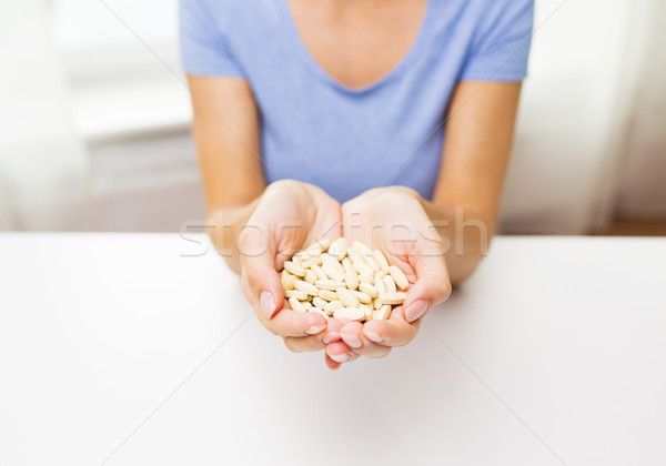 close up of woman hands with medicine or pills Stock photo © dolgachov