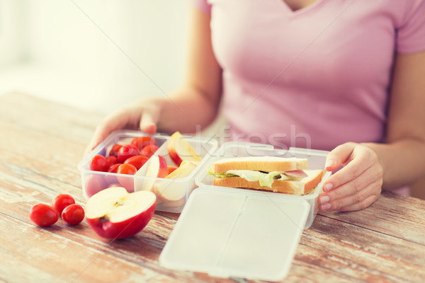 close up of woman with food in plastic container Stock photo © dolgachov
