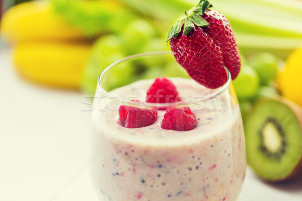 close up of glass with milk shake and fruits Stock photo © dolgachov