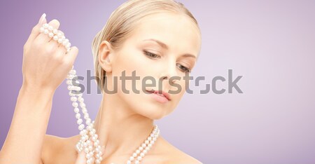close up of beautiful woman face with earring Stock photo © dolgachov