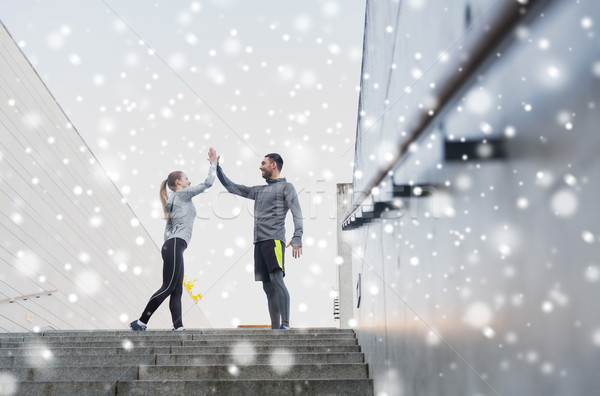 couple of sportsmen making high five outdoors Stock photo © dolgachov