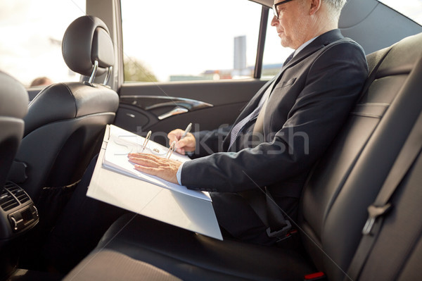 senior businessman with papers driving in car Stock photo © dolgachov
