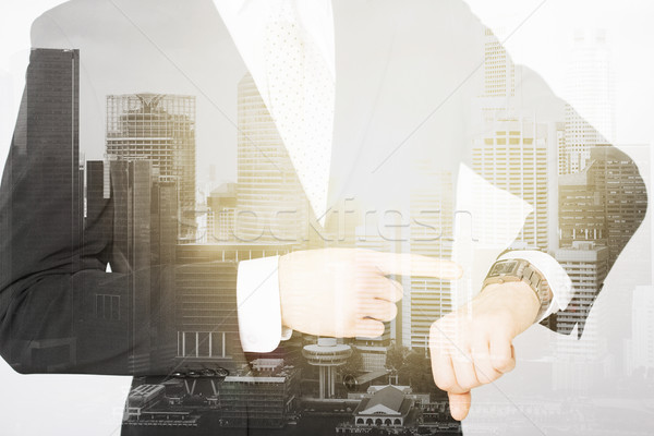 close up of businessman with wristwatch Stock photo © dolgachov