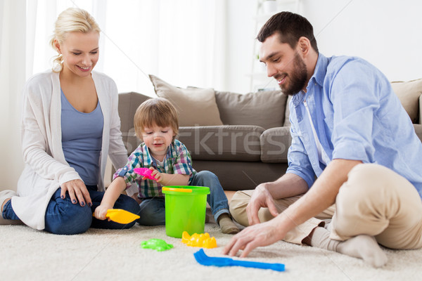 happy family playing with beach toys at home Stock photo © dolgachov