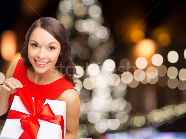 smiling woman in red dress with christmas gift box Stock photo © dolgachov
