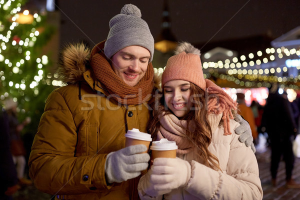 happy young couple with coffee at christmas market Stock photo © dolgachov