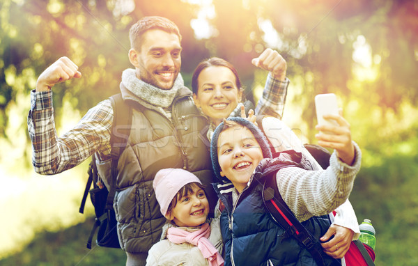 family with backpacks taking selfie by smartphone Stock photo © dolgachov