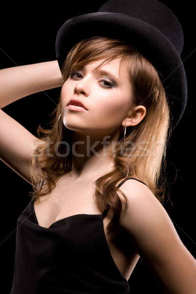 Vrouw zwarte jurk top hoed donkere foto Stockfoto © dolgachov