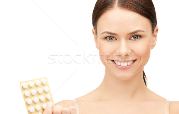 Stock photo: young beautiful woman with pills