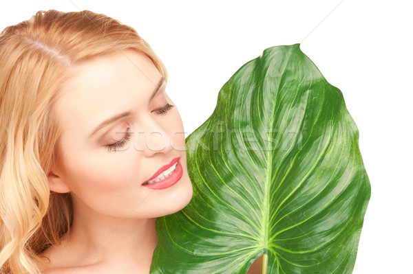 Stock photo: woman with green leaf over white