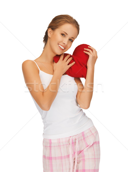 happy and smiling woman with heart-shaped pillow Stock photo © dolgachov