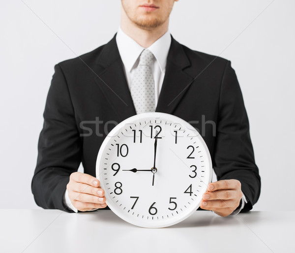 man with wall clock Stock photo © dolgachov