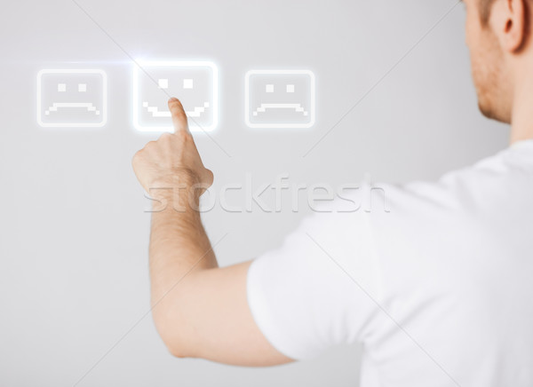 hand touching virtual screen with smile button Stock photo © dolgachov