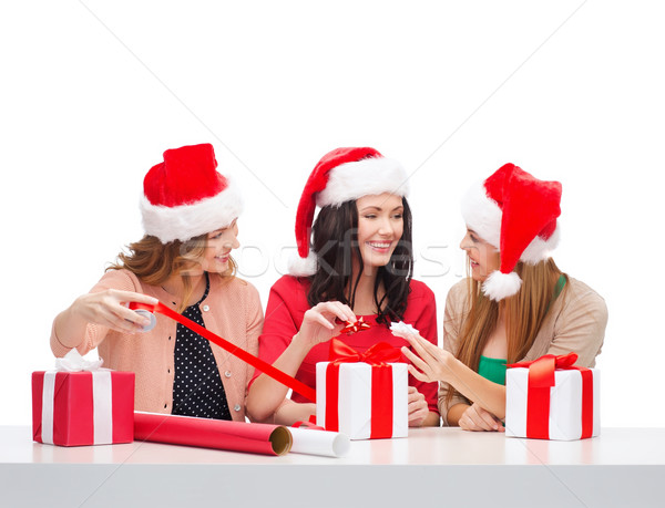 smiling women in santa helper hats with gift boxes Stock photo © dolgachov
