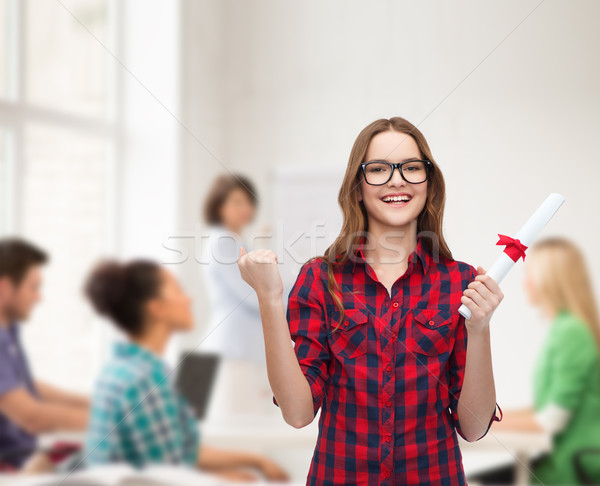 smiling female student in eyeglasses with diploma Stock photo © dolgachov