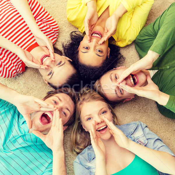 smiling people lying down on floor and screaming Stock photo © dolgachov