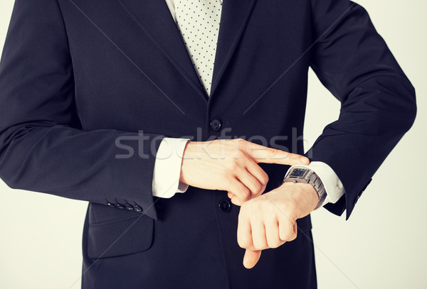 Mann schauen Armbanduhr Sitzung Arbeit Stock foto © dolgachov