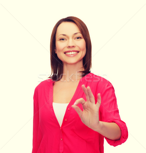 woman in casual clothes showing ok gesture Stock photo © dolgachov