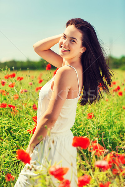 Sorridente mulher jovem papoula campo felicidade natureza Foto stock © dolgachov