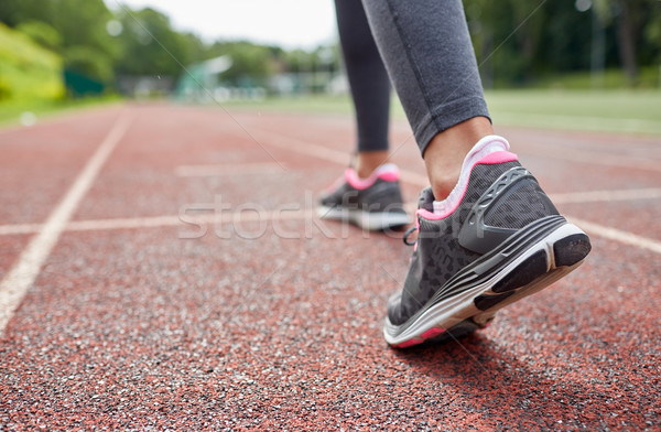 close up of woman feet running on track from back Stock photo © dolgachov