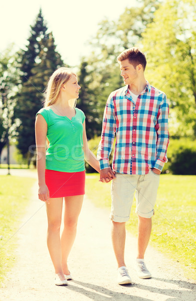 smiling couple walking in park Stock photo © dolgachov