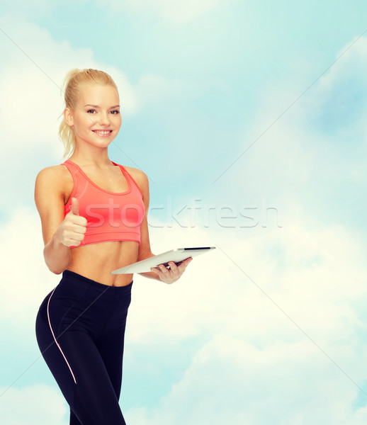 smiling sporty woman with tablet pc computer Stock photo © dolgachov