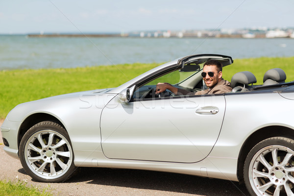Heureux homme conduite cabriolet voiture extérieur Photo stock © dolgachov