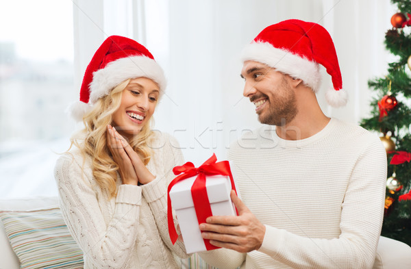 happy couple at home with christmas gift box Stock photo © dolgachov