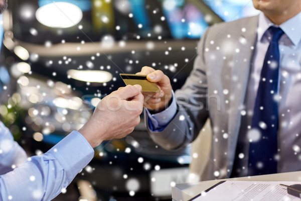 customer giving credit card to car dealer in salon Stock photo © dolgachov