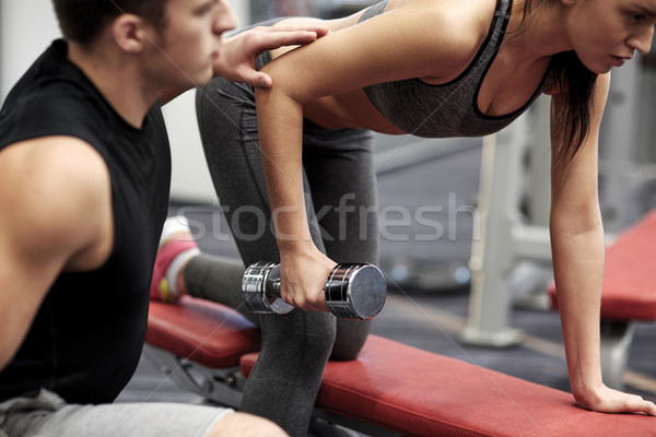 close up of couple with dumbbell exercising in gym Stock photo © dolgachov