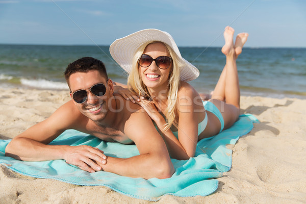 happy couple in swimwear lying on summer beach Stock photo © dolgachov