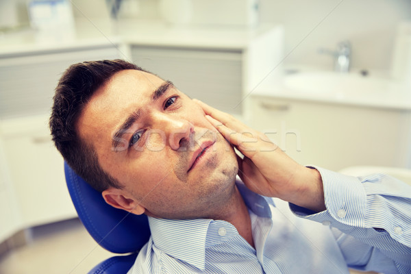 Adam diş ağrısı oturma diş sandalye insanlar Stok fotoğraf © dolgachov
