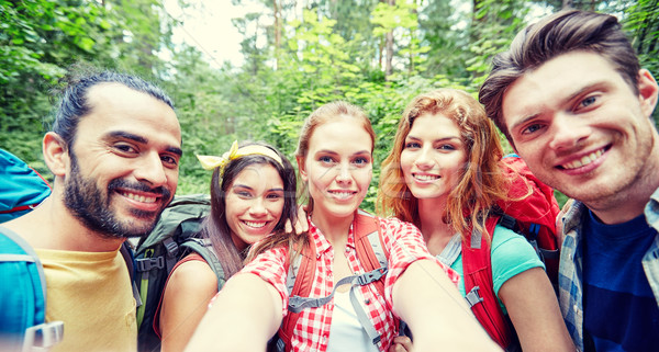 Stock photo: friends with backpack taking selfie in wood