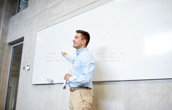 teacher pointing marker to white board at lecture Stock photo © dolgachov