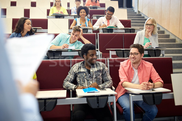 Stock photo: group of students with notebooks at lecture hall