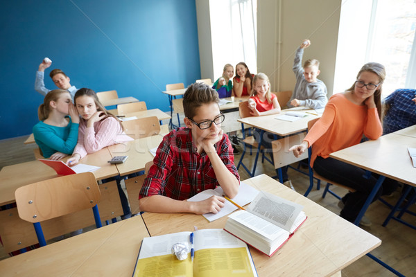 classmates laughing at student boy in school Stock photo © dolgachov