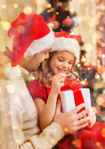 smiling father and daughter opening gift box Stock photo © dolgachov