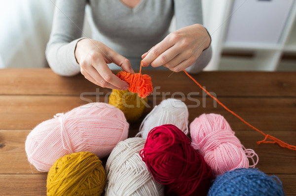 woman pulling yarn up into ball Stock photo © dolgachov