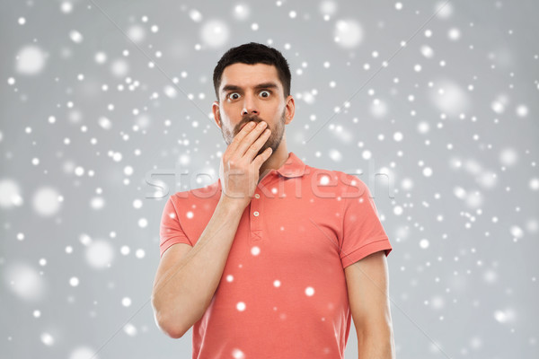 scared man in polo t-shirt over snow Stock photo © dolgachov