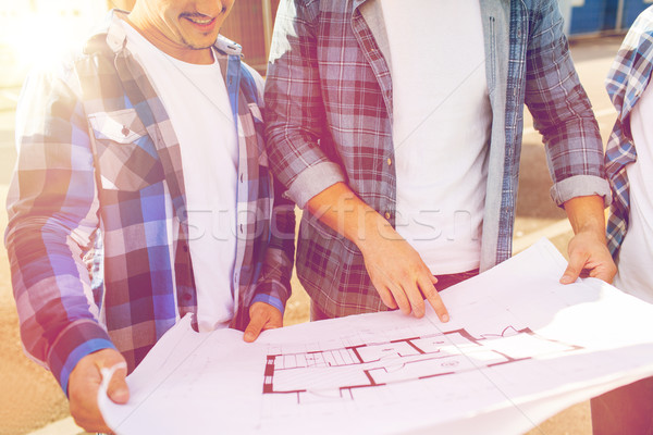 close up of smiling builders with blueprint Stock photo © dolgachov