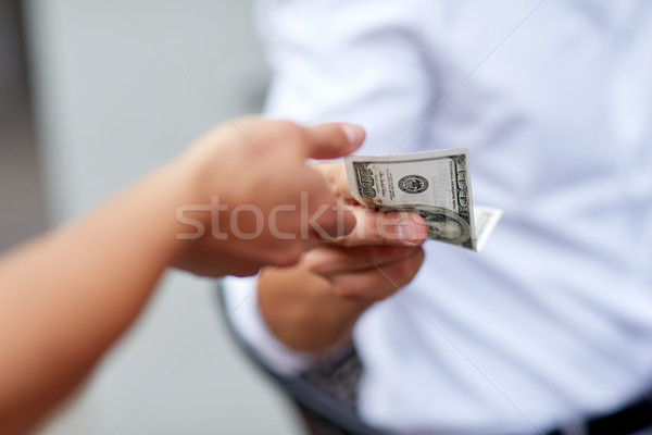 close up of hands giving and receiving dollar money Stock photo © dolgachov