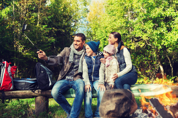 family with smartphone taking selfie near campfire Stock photo © dolgachov