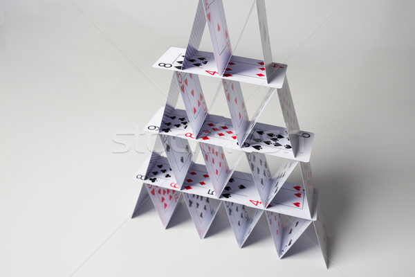 house of playing cards over white background Stock photo © dolgachov