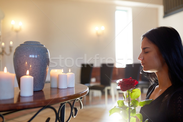 woman with rose and funerary urn at church Stock photo © dolgachov