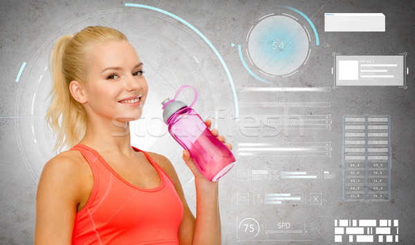 smiling sporty woman with water bottle Stock photo © dolgachov