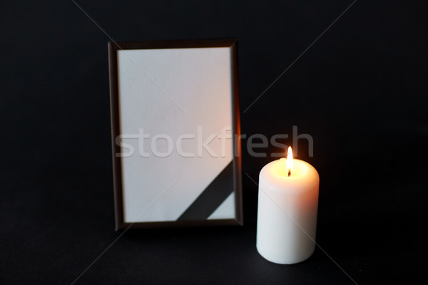 black ribbon on photo frame and candle at funeral Stock photo © dolgachov
