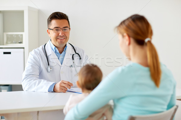 happy woman with baby and doctor at clinic Stock photo © dolgachov