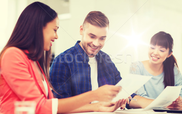 happy creative team or students working at office Stock photo © dolgachov