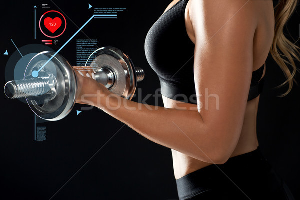 close up of woman with dumbbell and pulse Stock photo © dolgachov