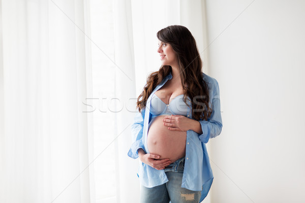 happy pregnant woman with big tummy at home Stock photo © dolgachov